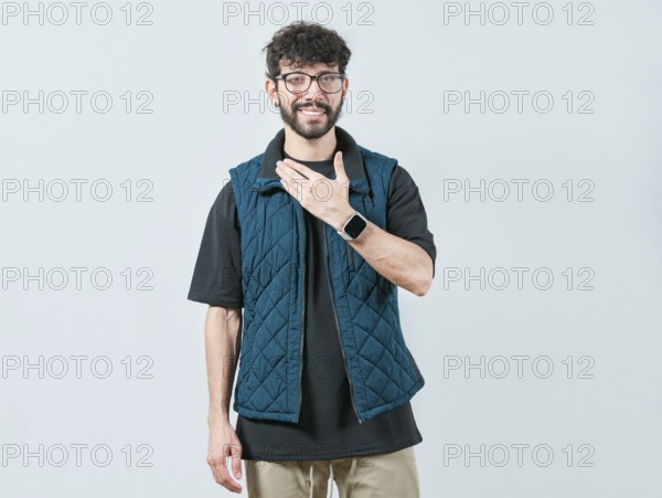 Young man making PLEASE gesture in sign language. Person gesturing PLEASE in nonverbal language