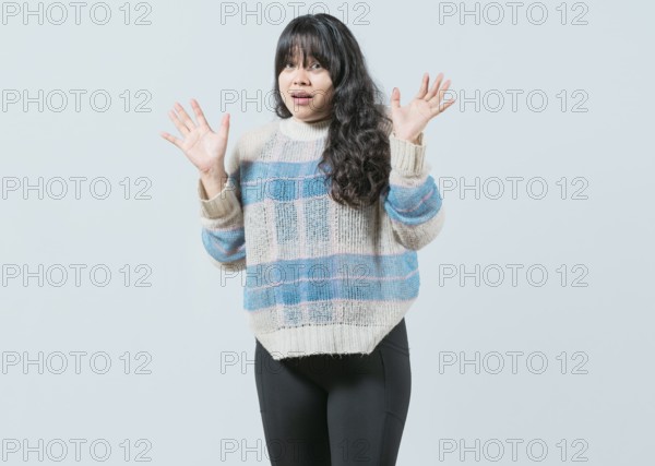 Scared asian woman with raised hands isolated. Young woman scared surprised with raised hands