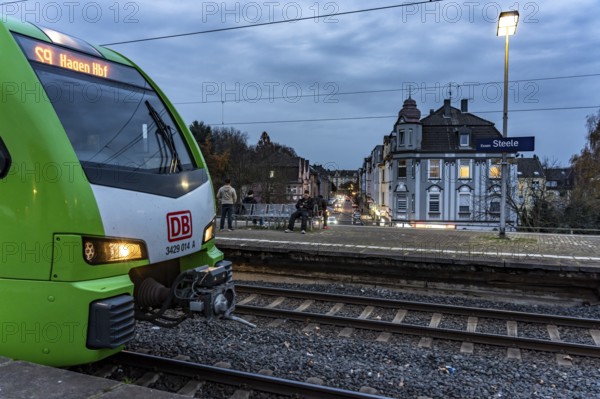 Essen-Steele S-Bahn station, passengers waiting for the train late afternoon, in autumn, Essen, North Rhine-Westphalia, Germany