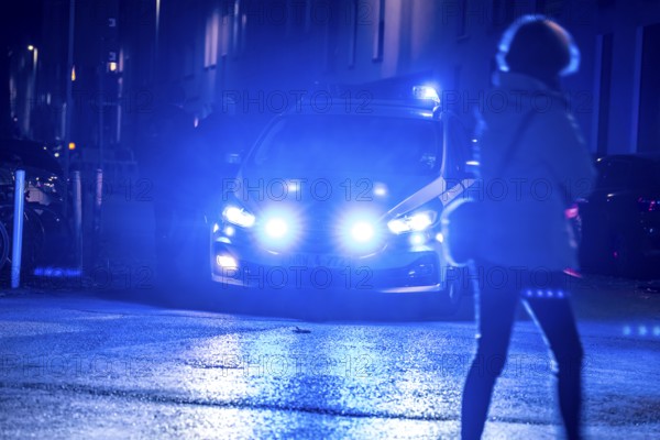 Police patrol car deployed with flashing lights, Essen, North Rhine-Westphalia, Germany