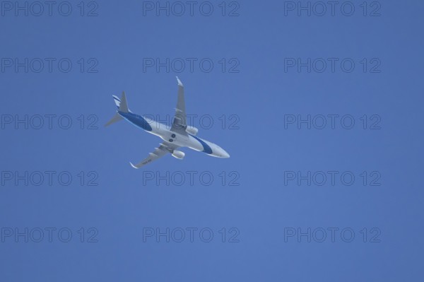Boeing 737 jet passenger aircraft of El Al Israel airlines flying in a blue sky, England, United Kingdom