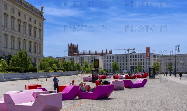 Colourful seating elements on the open space in front of the entrance to the Humboldt Forum, Berlin, Germany