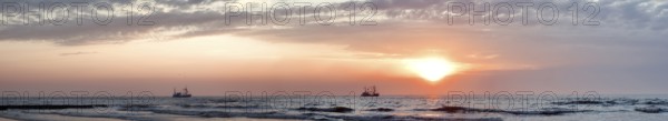 North Sea panorama crab fishermen in sunset mood