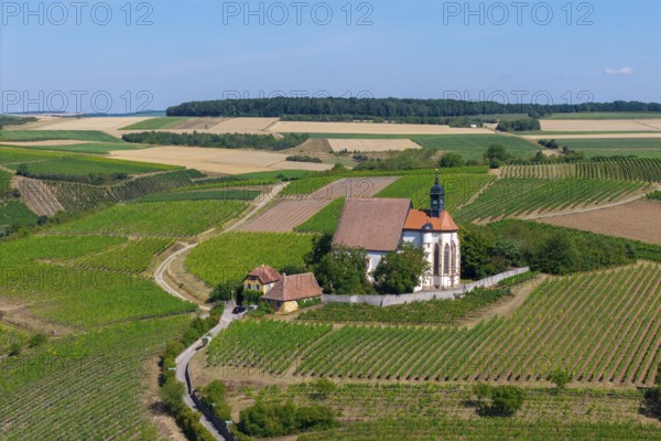 Pilgrimage church Maria im Weingarten, surrounded by green hills and fields under a sunny sky, aerial view, near Volkach am Main, Lower Franconia, Mainfranken, Bavaria, Germany