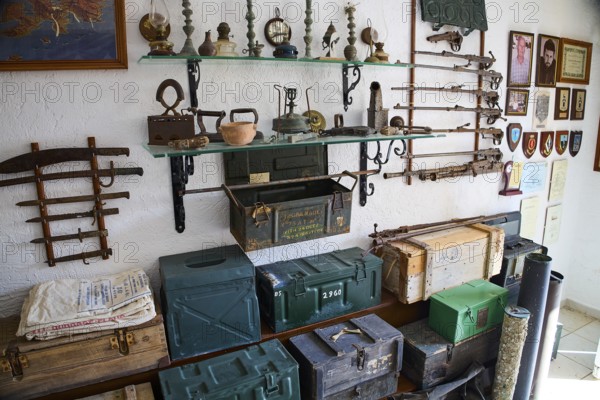 Shelves with antique weapons, lamps and crates in a military museum, war museum, military museum, private military museum, Platanos, Leros, WW2, Dodecanese, Greek Islands, Greece