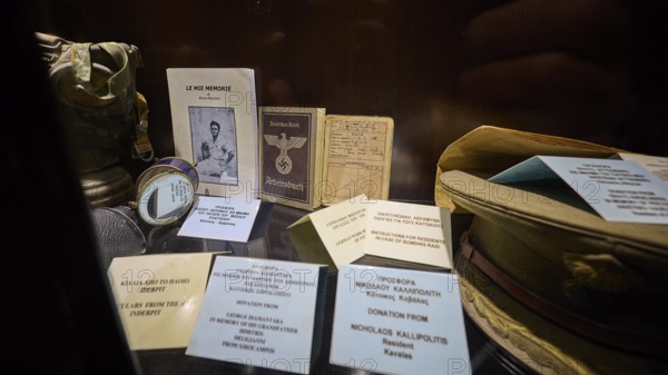 Display case with historical documents and memorabilia, including a book and pictures, workbook, war museum, military museum, tunnel museum, Lakki, Leros, WW2, Dodecanese, Greek Islands, Greece