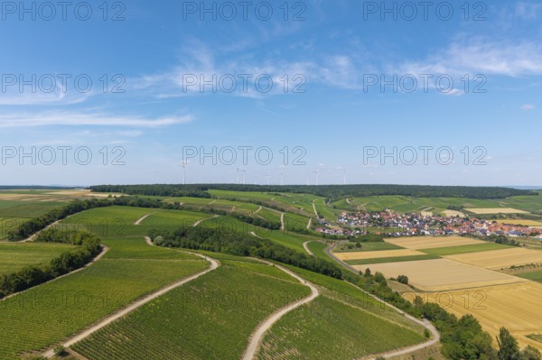 View of roads meandering through vineyards towards a village, with wind turbines in the background, Eisenheim near Volkach, aerial view, Mainfranken, Mainschleife, Franconia, Lower Franconia, Bavaria, Germany
