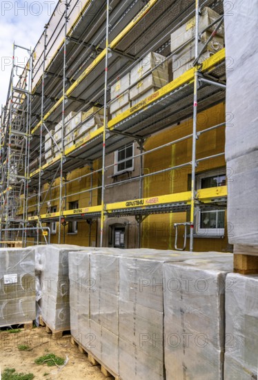 Energy refurbishment of an older residential building, thermal insulation with mineral wool insulation boards, mounted on the façade and then plastered, North Rhine-Westphalia, Germany
