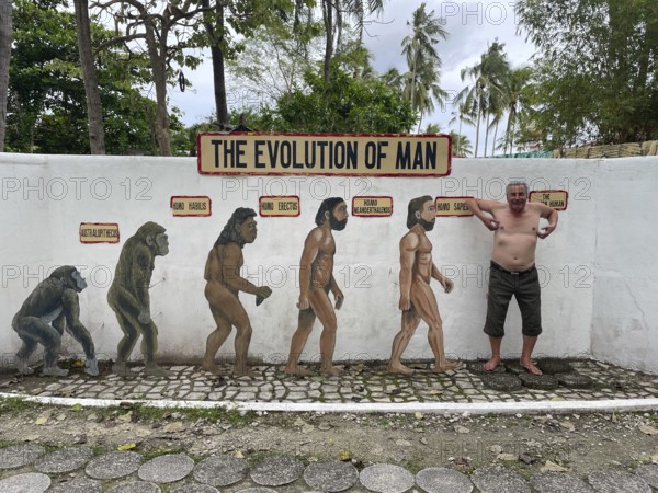 Evolution of anatomically modern man (Homo sapiens), parody, satire, funny, humour, scratching like a monkey, Negros, Philippines