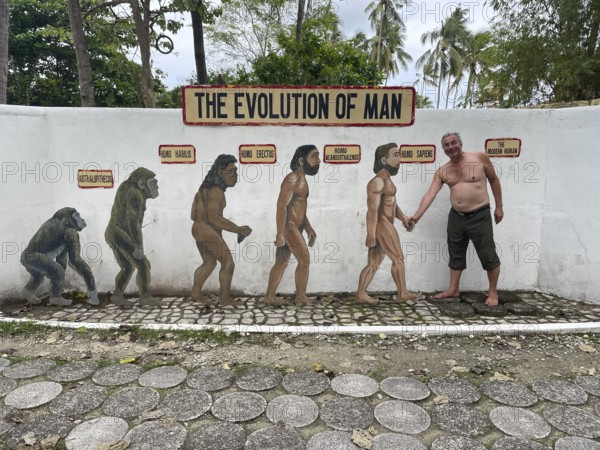 Evolution of anatomically modern man (Homo sapiens), parody, satire, funny, humour, shaking hands with the Neanderthal man, Negros, Philippines