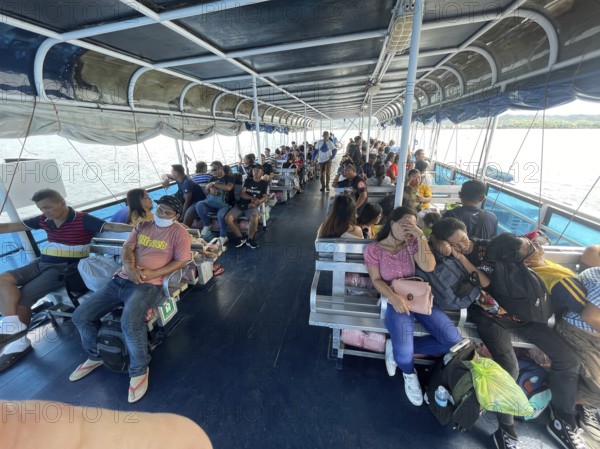 Ferry between Cebu and Negros, passengers on the upper deck, Philippines