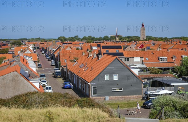 Westkapelle, Zeeland, Netherlands - Westkapelle. In the background the lighthouse 't Hoge Licht and the windmill De Noorman. Houses with red roofs