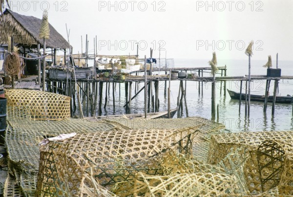 Wicker fish traps and wooden jetties in fishing village on stilts, Singapore, southeast Asia 1963