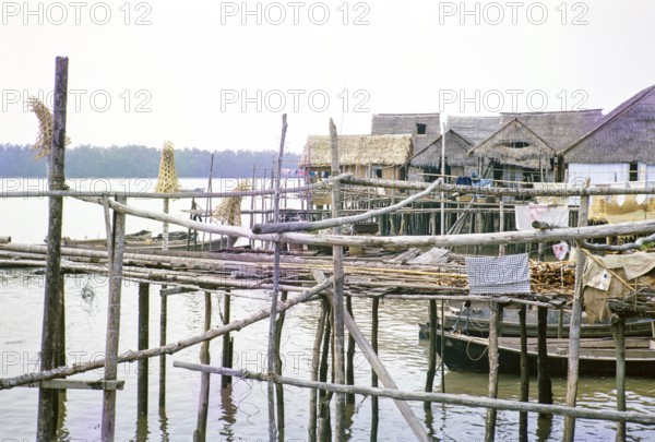 Attap houses and wooden jetties in fishing village on stilts, Singapore, southeast Asia 1963