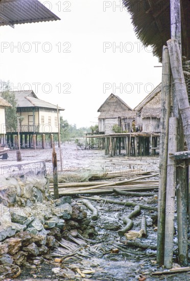 Low tide in fishing village of attap houses built on stilts, Singapore, southeast Asia 1963
