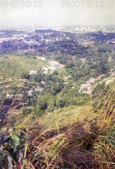 View over Bukit Purmei from Mount Faber towards city centre commercial area, Singapore, southeast Asia, 1965