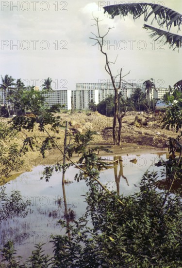 Destruction of farmland for construction site with modern blocks of flats residential housing, Singapore, southeast Asia, 1965