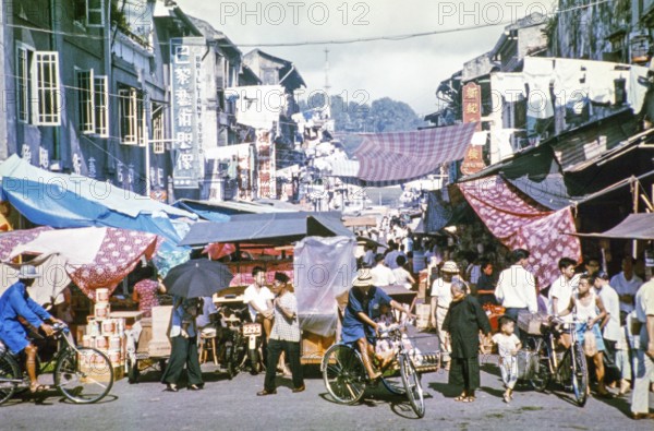 People at busy street market in Singapore, southeast Asia, c 1964