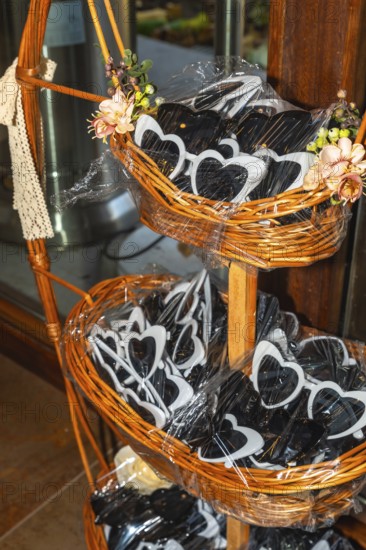 Heart shaped sunglasses are displayed in wicker baskets, adding a playful touch to wedding celebrations and awaiting guests