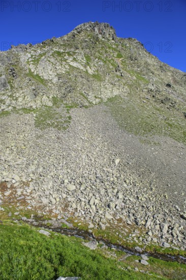 Smaller pieces of rock Rock stones lie eroded rock lies after landslide due to erosion on mountainside of rocky peak in Alps, Switzerland