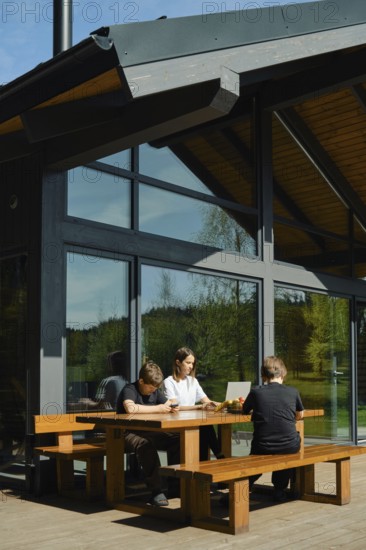 A woman develops mobile games and her sons are reviewing, testing, and refining the functionality and user experience of a mobile game across different platforms