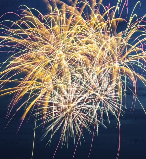 Brilliant fireworks with bright colours light up the night, atmospheric, magnificent, intense with many luminous colours, nocturnal, at night, blue night sky, Heligoland island festival in summer, symbolic image also for New Year's Eve, New Year's Eve fireworks, bright, colourful, many colourful traces of light, lively glitter, night, Heligoland island, Schleswig-Holstein, GermanyHeligoland island, North Sea, Schleswig-Holstein, Germany