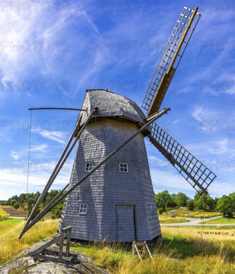 Historic windmill in an epic summer landscape near the burial ground of Stenhusbacken and the village of Sunnersberg near Lidköping, Västergötland, Västra Götalands län, Sweden