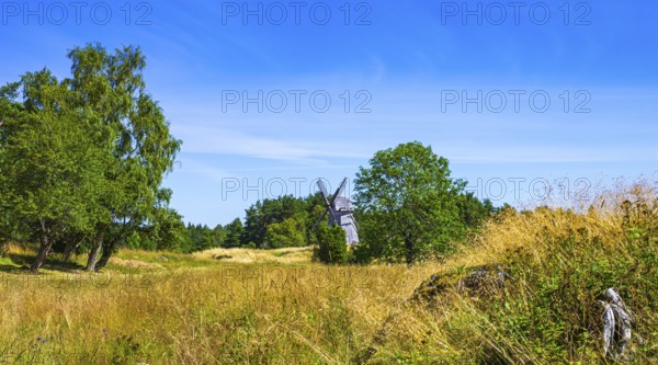 Epic summer landscape with historic windmill near the burial ground of Stenhusbacken and the village of Sunnersberg near Lidköping, Västergötland, Västra Götalands län, Sweden