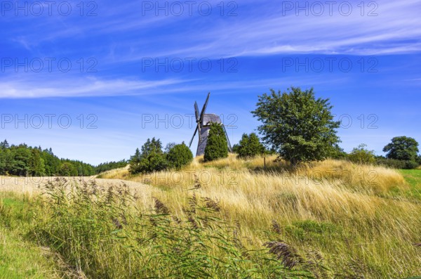 Historic windmill in an epic summer landscape near the burial ground of Stenhusbacken and the village of Sunnersberg near Lidköping, Västergötland, Västra Götalands län, Sweden