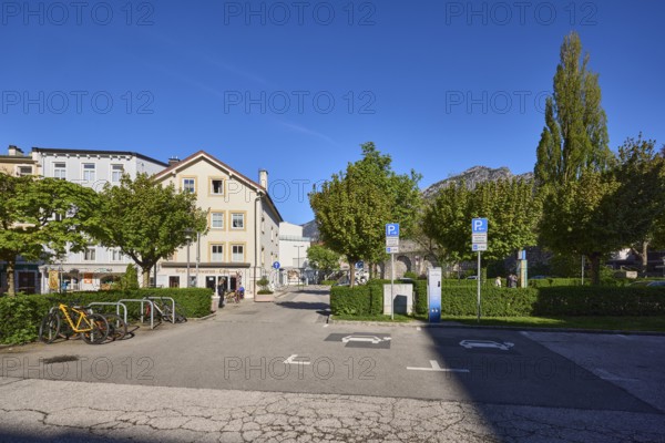 Car park, houses, building, car park, bicycle stand, bicycle, trees, hedge, blue sky, cloudless, Spitalgasse, Bad Reichenhall, Berchtesgadener Land district, Bavaria, Germany