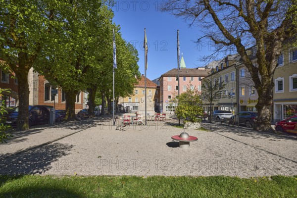 Square, general architecture, flagpoles, flags, trees, lawn, blue sky, cloudless, Unterer Lindenplatz, Bad Reichenhall, Berchtesgadener Land district, Bavaria, Germany