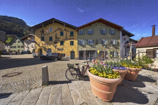 Old town, historic houses, air fresco, facade, windows, doors, square, alleyway, cobblestones, sandstone slabs, vehicles, bollards, flower pots, blue sky, Sebastianigasse, Florianiplatz, Bad Reichenhall, Berchtesgadener Land district, Bavaria, Germany