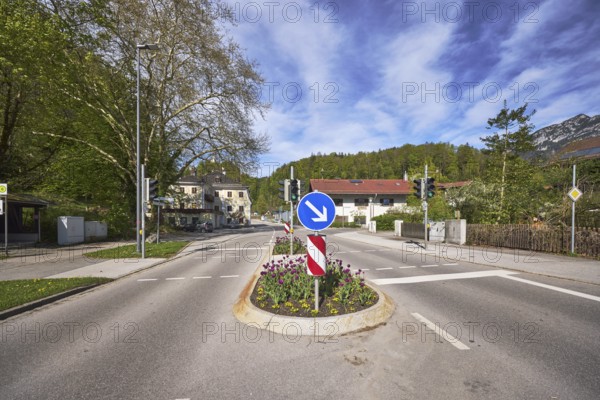 Traffic island, traffic lights, pedestrian crossing, lantern, multi-family houses, trees, flower bed, mountain landscape, hill, coniferous forest, blue sky, cumulus clouds, cirrostratus clouds, Thumseestraße, Bad Reichenhall, Berchtesgadener Land district, Bavaria, Germany