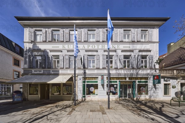 Kur-Apotheke, historical pharmacy, building, flagpoles, flags, facade, windows, entrance, doors, blue sky, cirrostratus clouds, Ludwigstraße, Bad Reichenhall, district Berchtesgadener Land, Bavaria, Germany