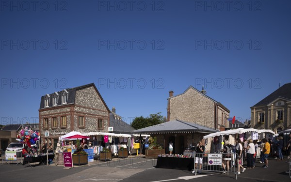 Weekly market with regional products, behind it co-operative bank, savings bank Crédit Agricole, Étretat, Normandy, Seine-Maritime, France