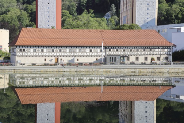 Armoury museum built in 1668 with modern skyscrapers and reflection, half-timbered house, pond, Suhl, Franconia, Thuringia, Germany
