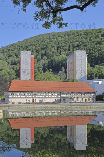Armoury museum built in 1668 with two modern skyscrapers and reflection, half-timbered house, pond, cityscape, mountain, forest, Thuringian Forest, Suhl, Franconia, Thuringia, Germany