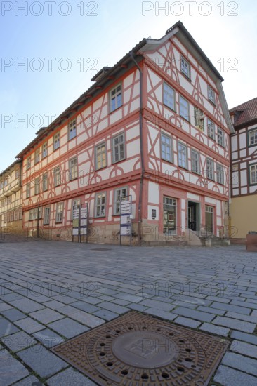 Red Luther House and square manhole cover with town coat of arms, cobblestones, view from below, ground, half-timbered house, Lutherplatz, Schmalkalden, Franconia, Thuringia, Germany