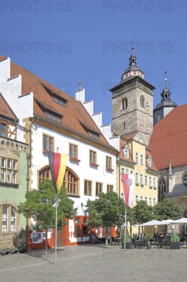 Houses and German national flag with Thuringian state flag, St George's Church, Altmarkt, Schmalkalden, Franconia, Thuringia, Germany