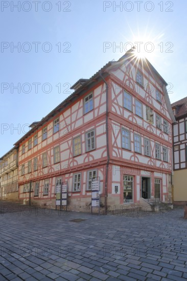 Red half-timbered house against the light, Lutherhaus, Lutherplatz, Schmalkalden, Franconia, Thuringia, Germany