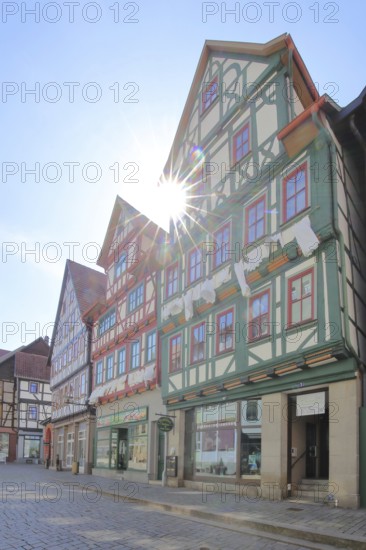 Red, green and brown half-timbered houses against the light, colourful, Auer Gasse, Schmalkalden, Franconia, Thuringia, Germany