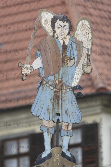 Figure at the Luitpold fountain built in 1911, fountain, angel, sword, stabbing weapon, beam balance, symbol, Justitia, sheet metal, metal, hotel, Schlundhaus, inscription, depth of field, blur, market square, Bad Königshofen, Rhön, Lower Franconia, Franconia, Bavaria, Germany