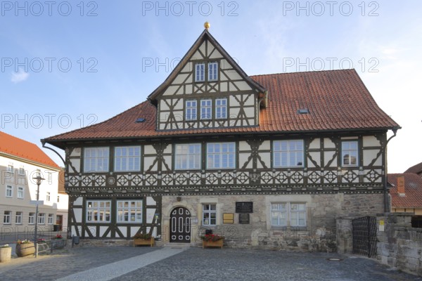 Historic official residence built in 1665, half-timbered house, hipped roof, Themar, fieldstone, Thuringia, Germany