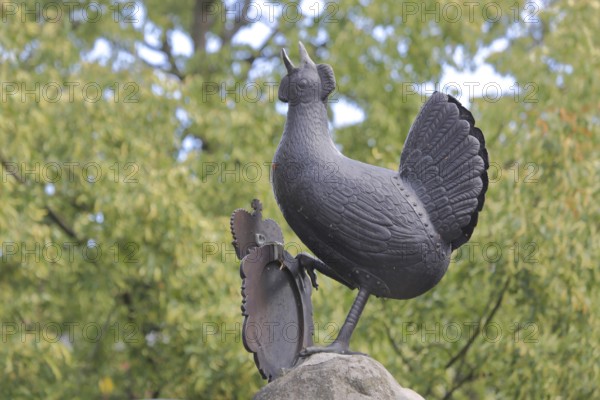Grey bronze sculpture at the Hennebrunnen fountain, bird figure, screaming, tail feathers, market square, Ilmenau, Thuringian Forest, Thuringia, Germany