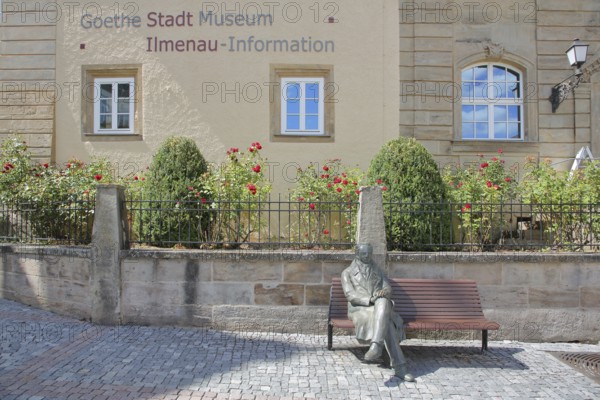 Sculpture of Johann Wolfgang von Goethe sitting on a bench, GoetheStadtMuseum, Amtshaus, Goethemuseum, tourist information centre, inscription, market square, Ilmenau, Thuringian Forest, Thuringia, Germany