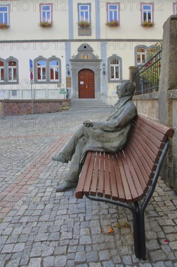 Johann Wolfgang von Goethe by Klaus Gutting sitting on the bench, arms, bronze sculpture, looking, monument, modern art, GoetheStadtMuseum, Amtshaus, town hall, door, market place, Ilmenau, Thuringian Forest, Thuringia, Germany