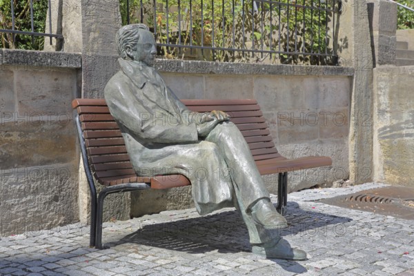 Johann Wolfgang von Goethe by Klaus Gutting sitting on the bench, bronze sculpture, looking, arms, monument, modern art, GoetheStadtMuseum, Amtshaus, market square, Ilmenau, Thuringian Forest, Thuringia, Germany