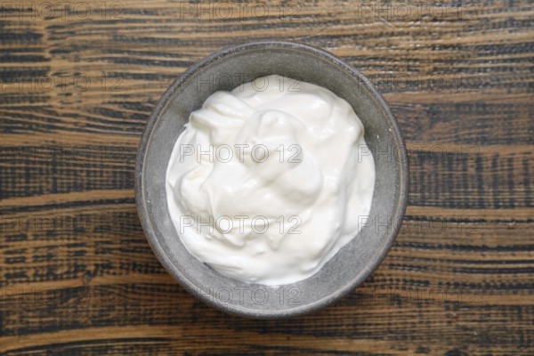 Overhead view of a bowl with sour cream or greek yoghurt