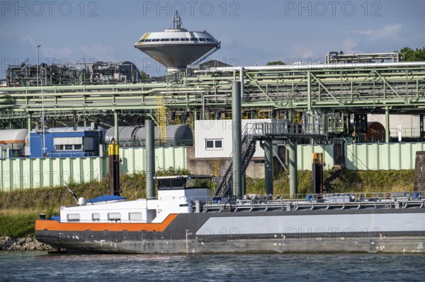 Scenery of the Chempark Leverkusen, Bayer Leverkusen, chemical park, chemical plant, river Rhine, cargo ship, water tower Leverkusen, North Rhine-Westphalia, Germany