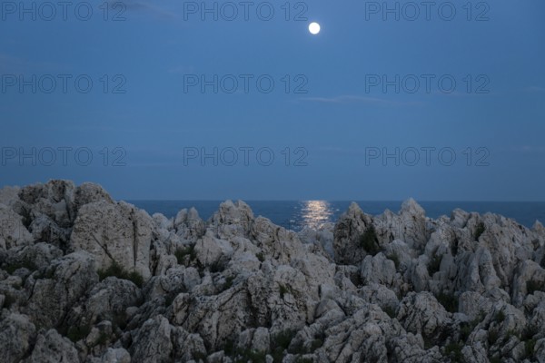 Rocks by the sea and full moon, Cap Martin, near Menton, Alpes Maritimes, Provence Alpes Cote d'Azur, French Riviera, South of France, France